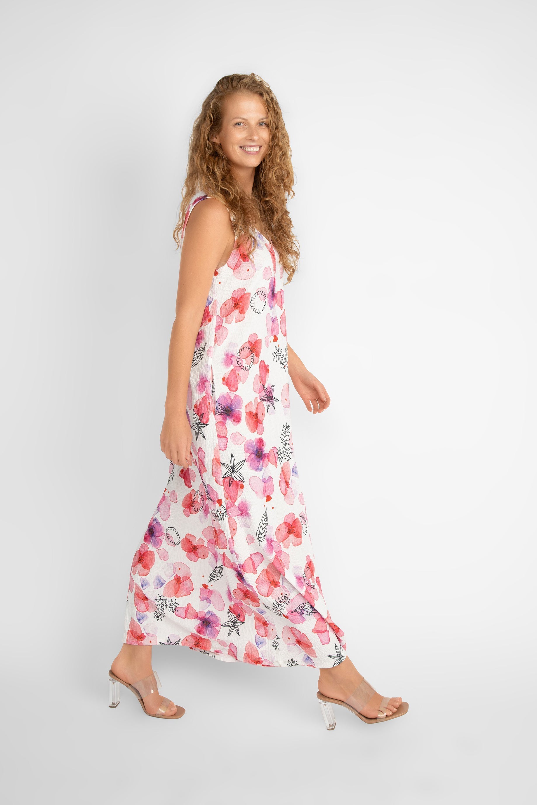Side view of Compli K (33565) Women's Sleeveless V-neck Printed Maxi Dress in a White with Pink Florals and Black Illustrations
