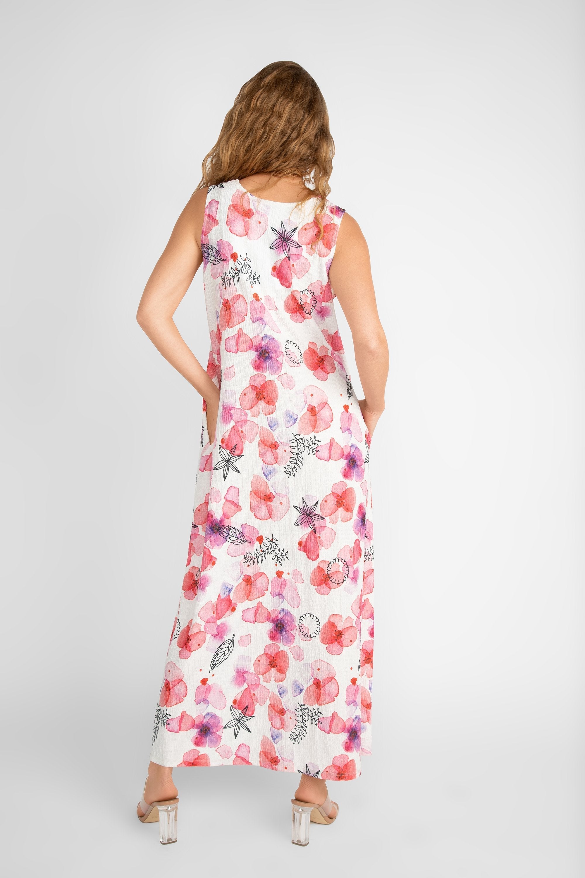 Back view of Compli K (33565) Women's Sleeveless V-neck Printed Maxi Dress in a White with Pink Florals and Black Illustrations