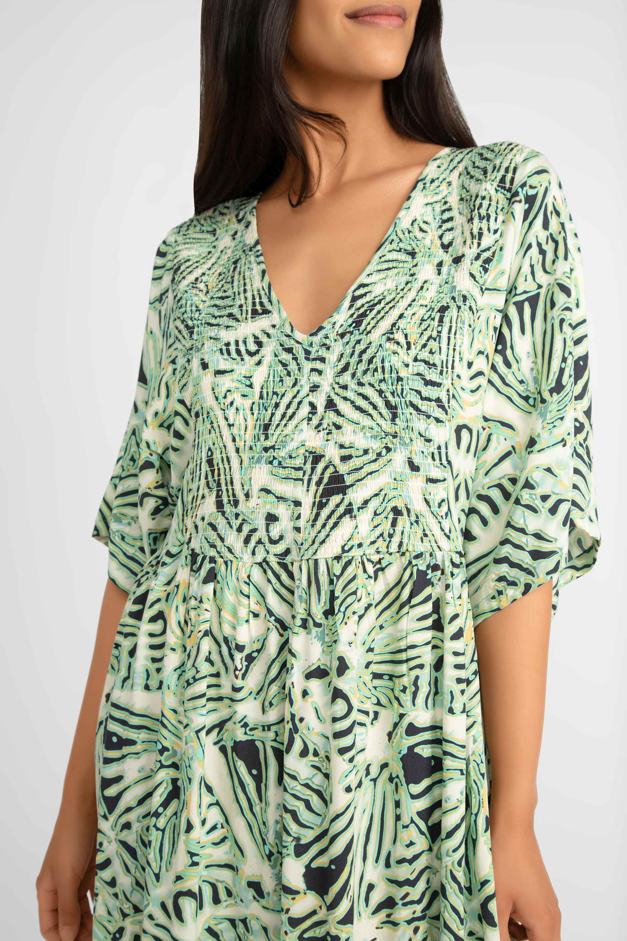 Close up of v-neck on Soya Concept (40629) Women's Short Sleeve Aqua Foliage Printed Maxi Dress with smocked bodice