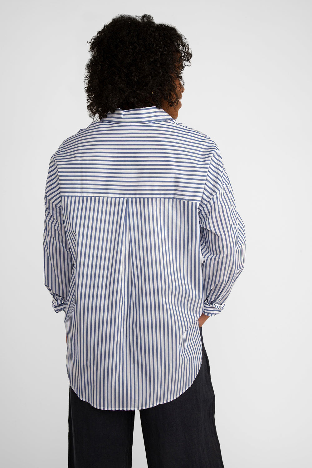 Back view of Carre Noir (6866) Women's Long Sleeve Blue & White Striped Button Up Shirt With Black Flowers along the front hem and lower half of the top