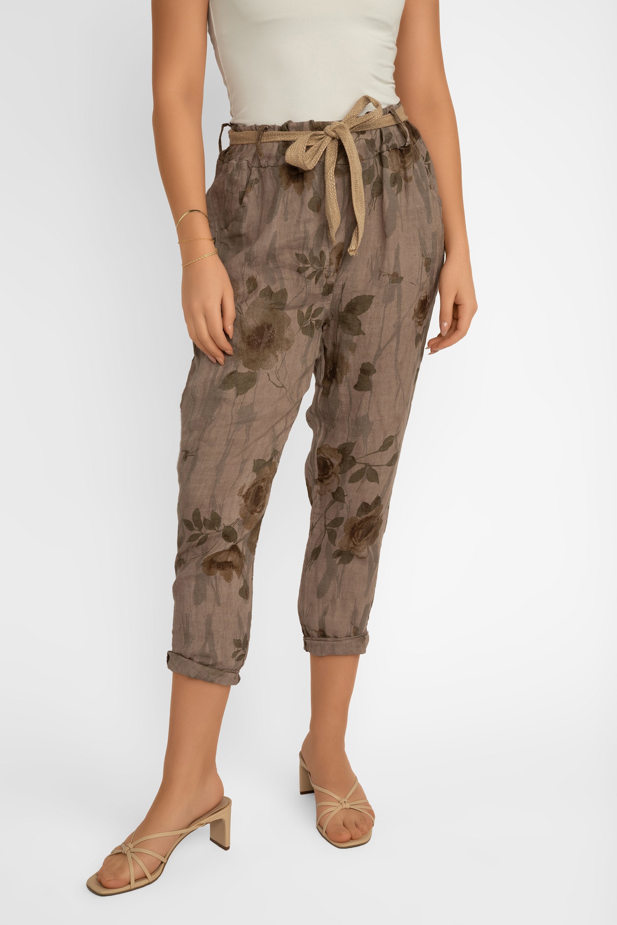 Front view of Elissia (CM20847) Women's Slim Fit Cropped Floral Print Linen Pants With Belt in Brown