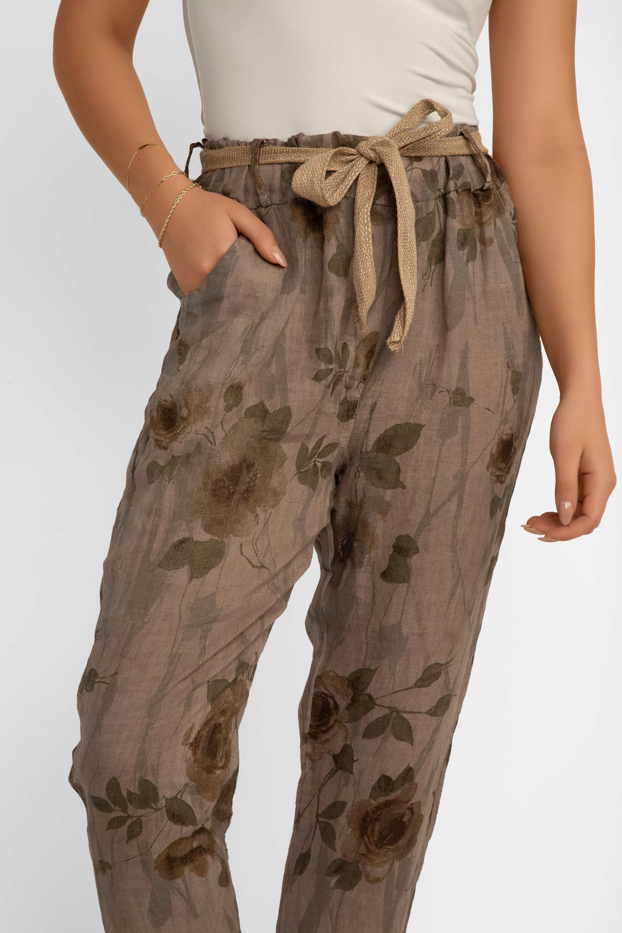 Front view showing pockets on Elissia (CM20847) Women's Slim Fit Cropped Floral Print Linen Pants With Belt in Brown