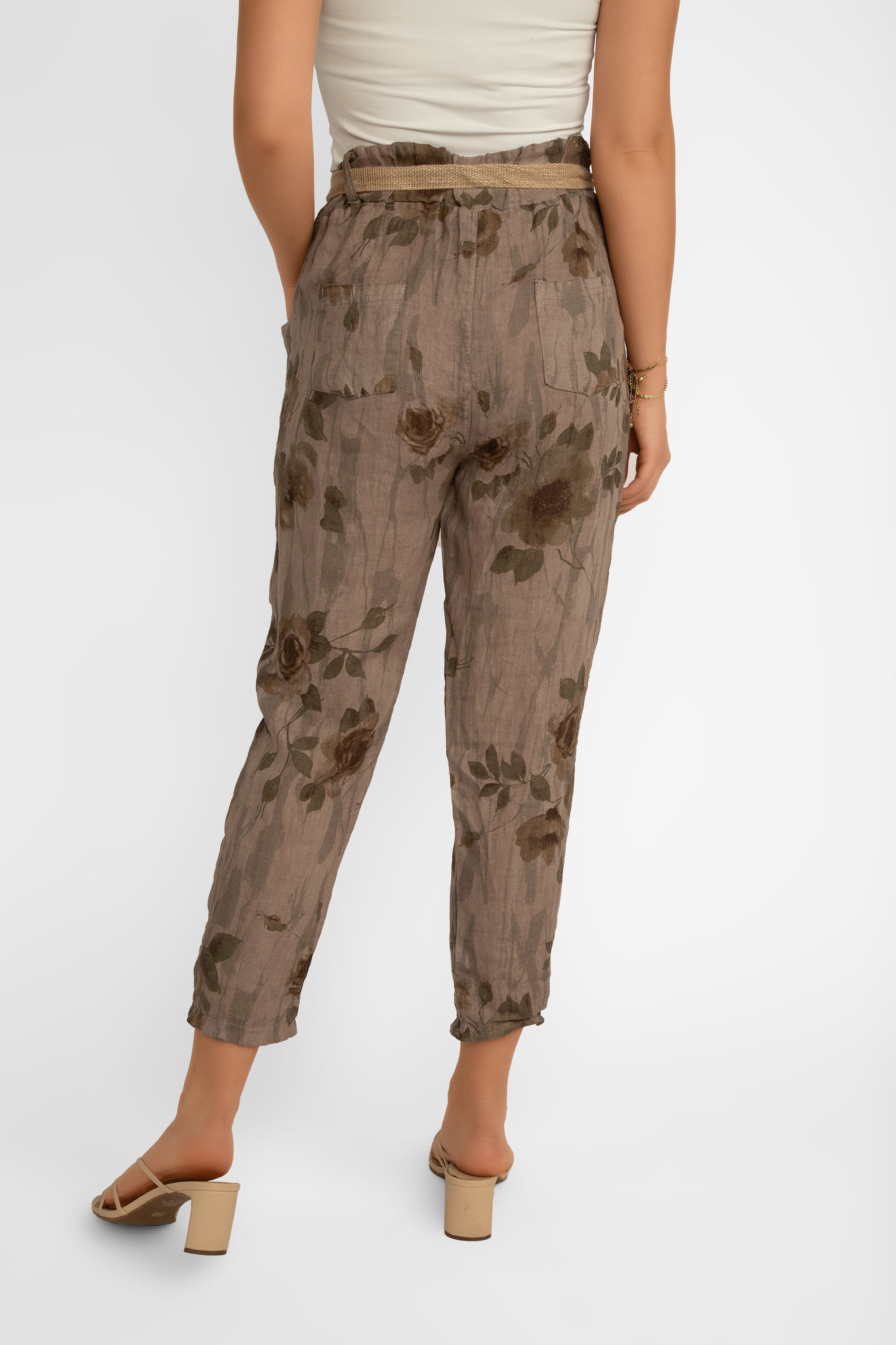 Back view showing back pockets on Elissia (CM20847) Women's Slim Fit Cropped Floral Print Linen Pants With Belt in Brown
