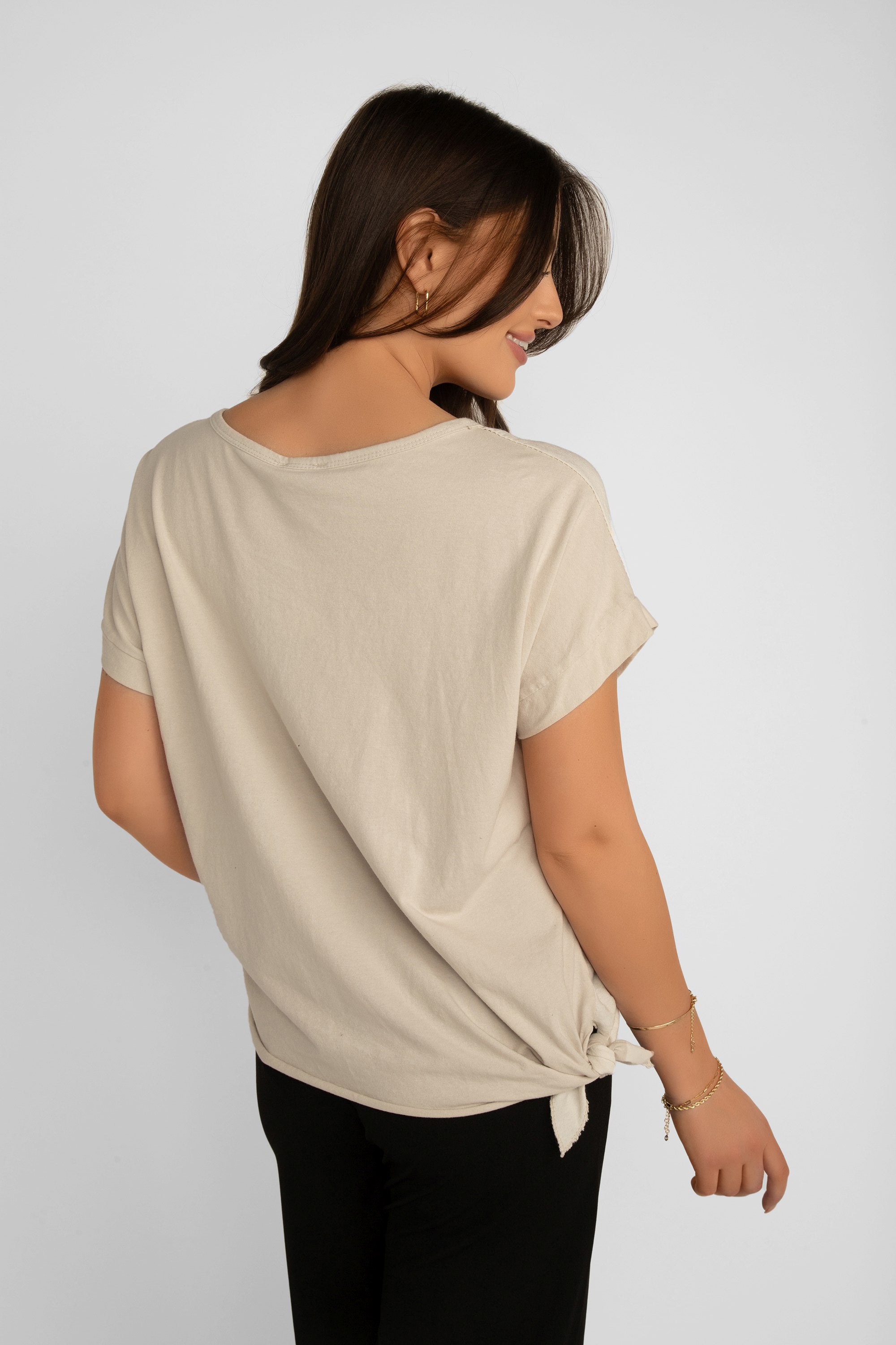 Back view of Elissia (LX35816) Women's Short Sleeve Cotton Blend Top with Foil Flower and Sequin Trim in Beige