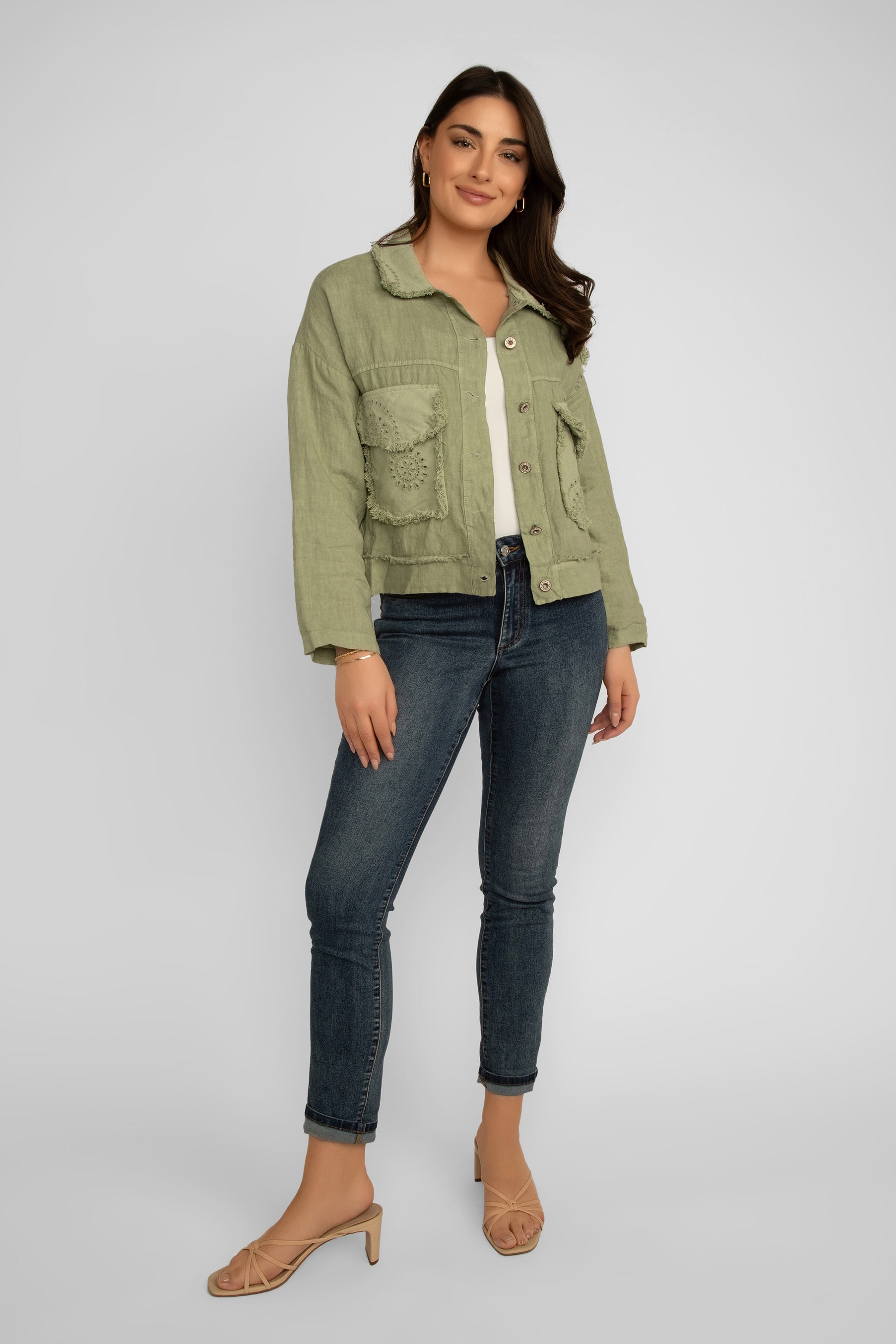 Full body front view of Elissia (NF20493) Women's Long Sleeve Frayed Hem Patch Pocket Jacket with Eyelet Lace Detail in Olive