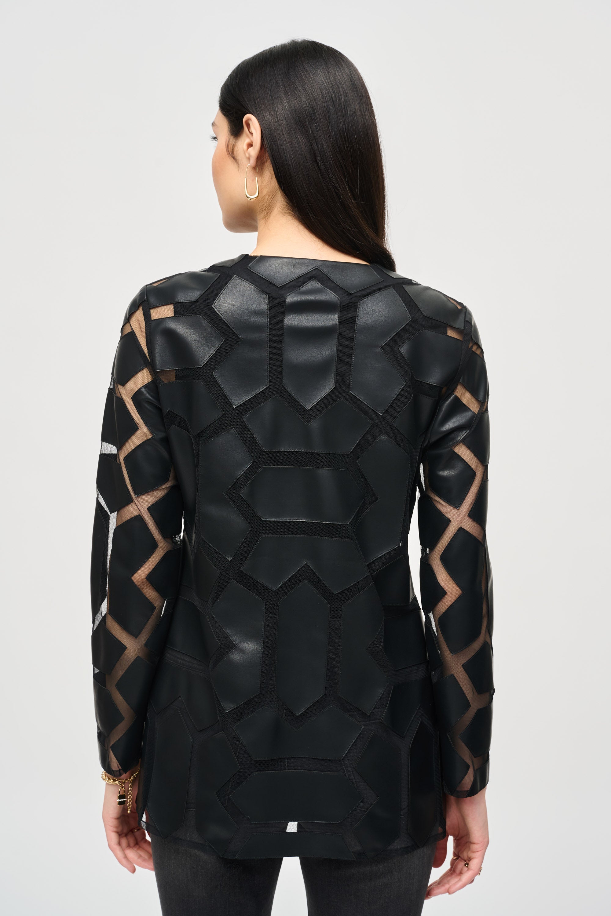 Back view of Joseph Ribkoff (241905F24) Women's Long Sleeve Faux Leather Hexagon and Mesh Crew Neck Jacket in Black with Hook and Eye Front Closure