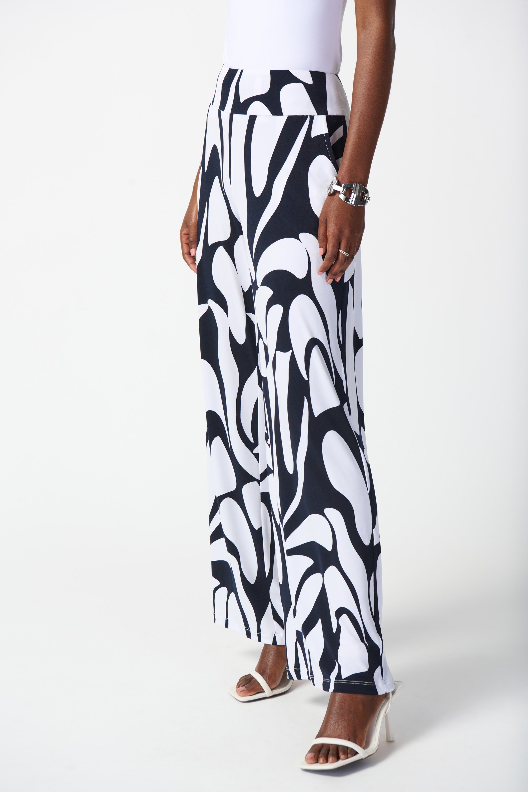 Front view of Joseph Ribkoff (242103) Women's Silky Knit Wide Leg Pants with Pockets in a Navy & White Geometric Print