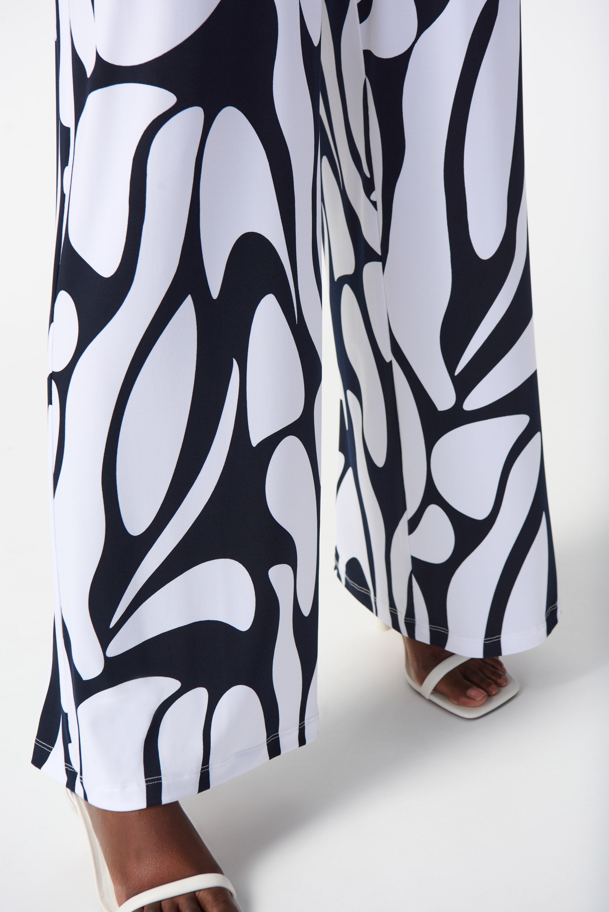 Front close up of print on Joseph Ribkoff (242103) Women's Silky Knit Wide Leg Pants with Pockets in a Navy & White Geometric Print