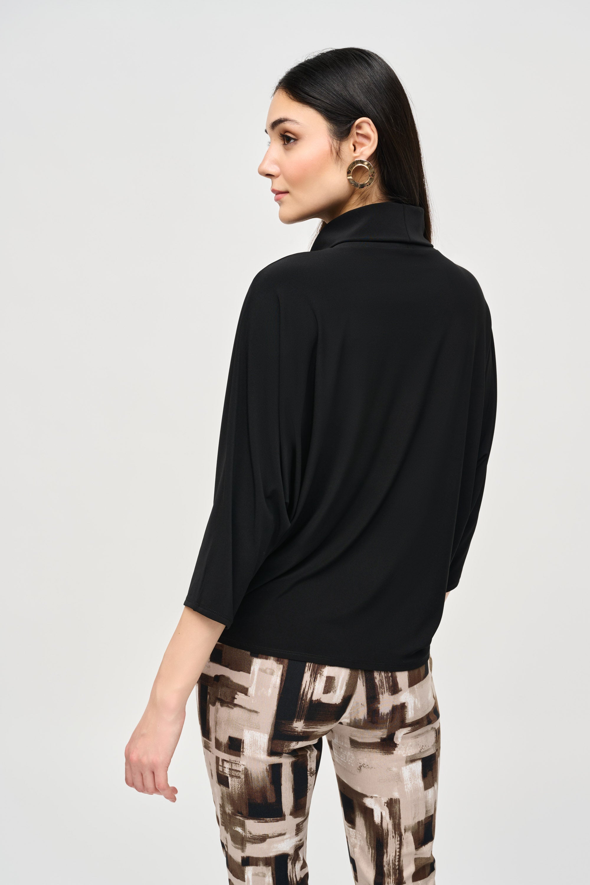 Back view of Joseph Ribkoff (243159) Women's 3/4 Dolman Sleeve Turtleneck Top with Eyelet Detail and Boxy Silhouette in Black