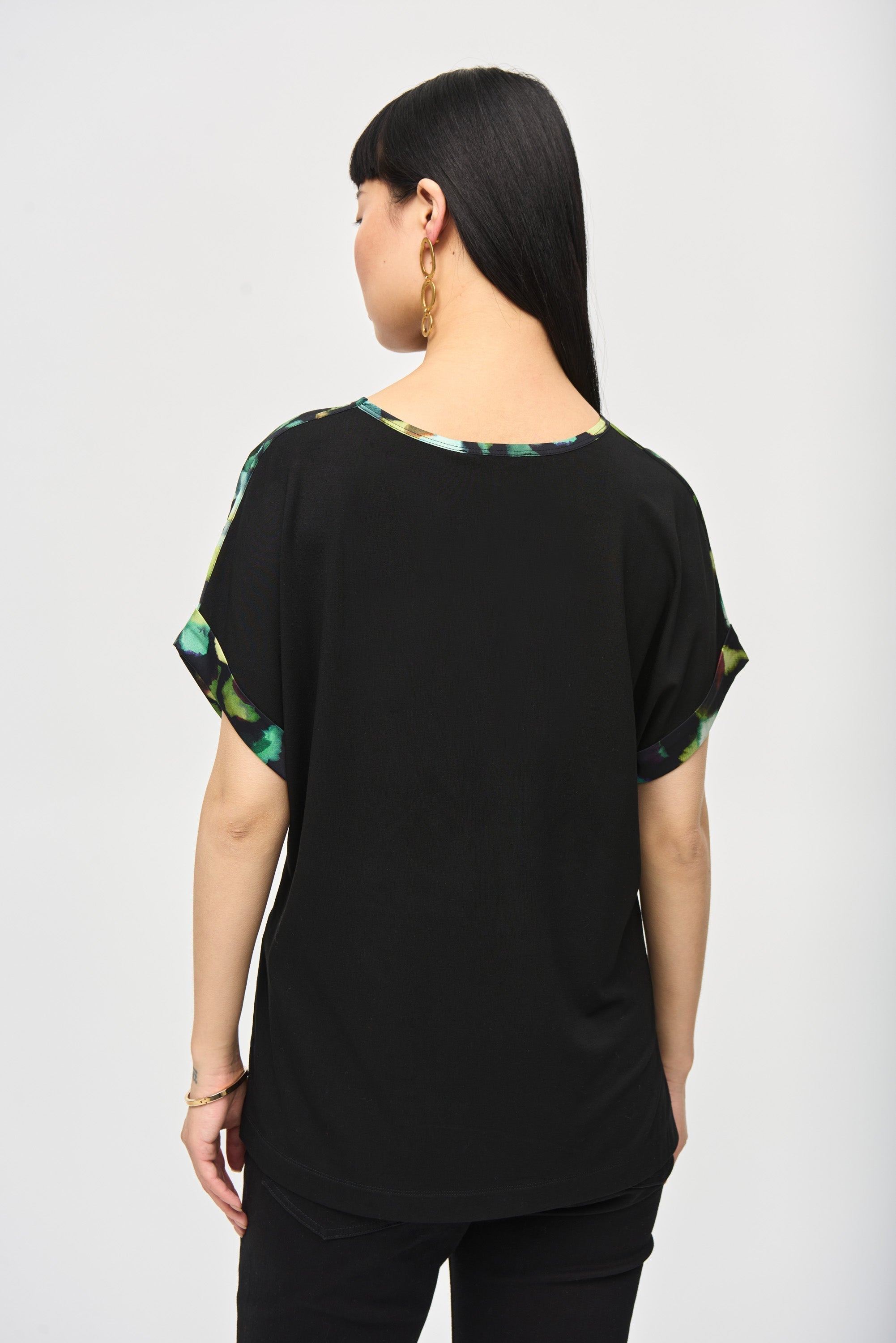 Back view of Joseph Ribkoff (243938) Women's Short Dolman Sleeve Top With Green Abstract Printed Satin Front and Black Silky Knit Back