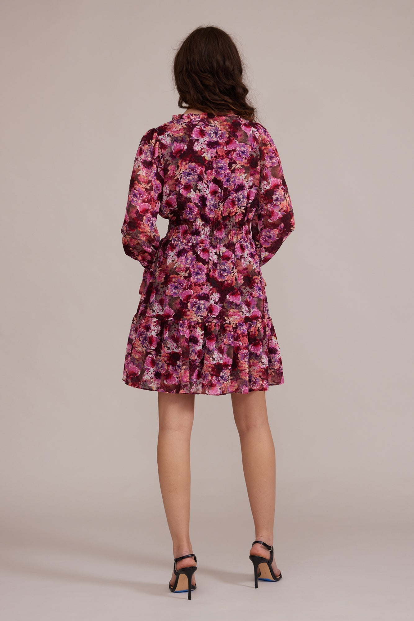 Back view of Lucy Paris (DR8007) Women's Long Puff Sleeve Mini Dress With Split V-Neck and Ruffle Trim in a Pink Floral Print