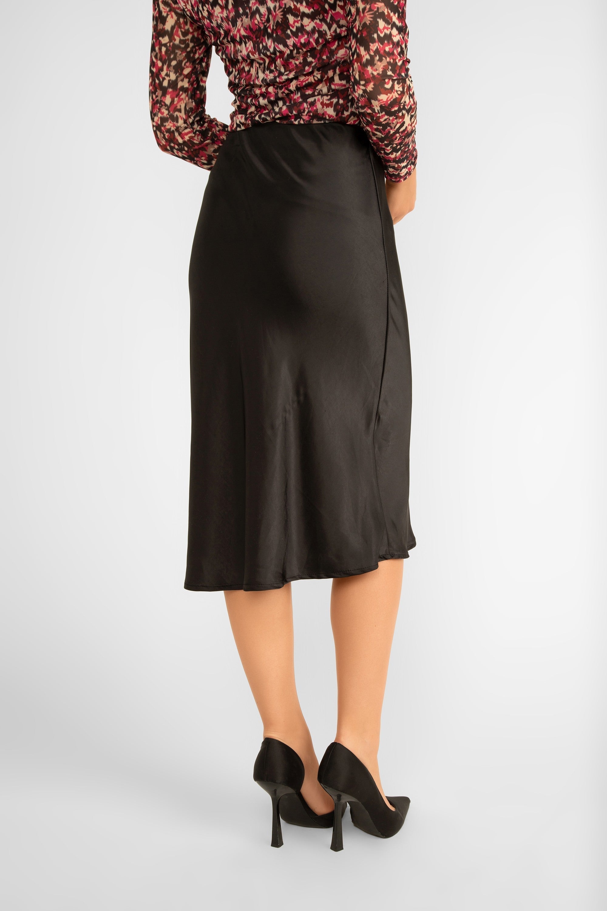 Back view of ASTRID (18-32013F) R & B Skirt - Women's Midi  Satin Skirt with Modest Side Split and Side Button Detail in Black