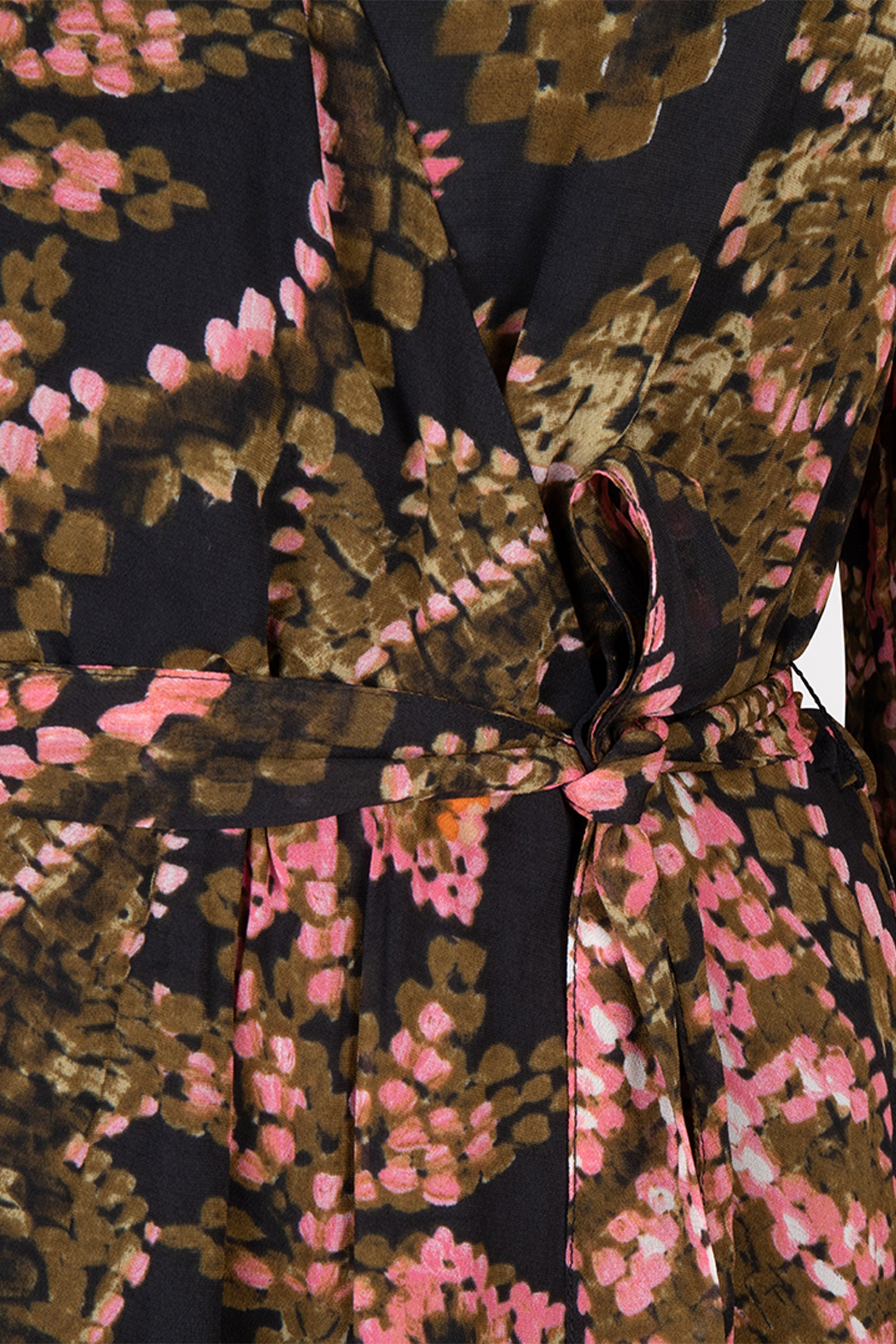 Close up of tie waist on Esqualo (F2414504) Women's Long Sleeve, Knee Length Faux Wrap Dress with Elastic Tie Waist in a Pink and Green Stitched Floral Print over a Dark Background