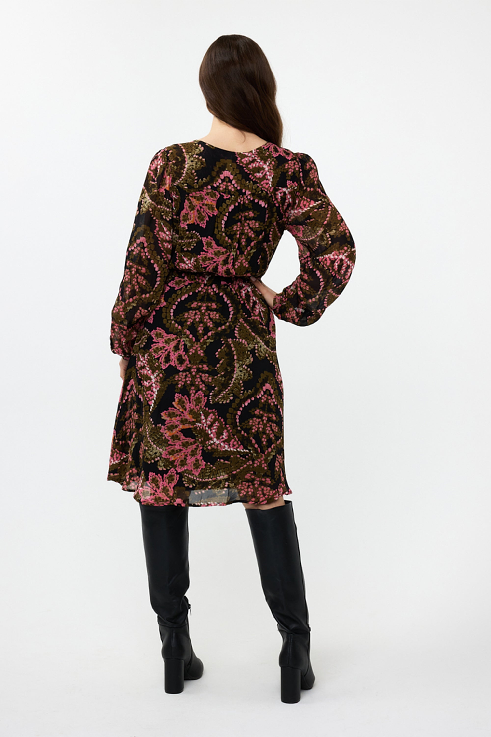 Back view of Esqualo (F2414504) Women's Long Sleeve, Knee Length Faux Wrap Dress with Elastic Tie Waist in a Pink and Green Stitched Floral Print over a Dark Background