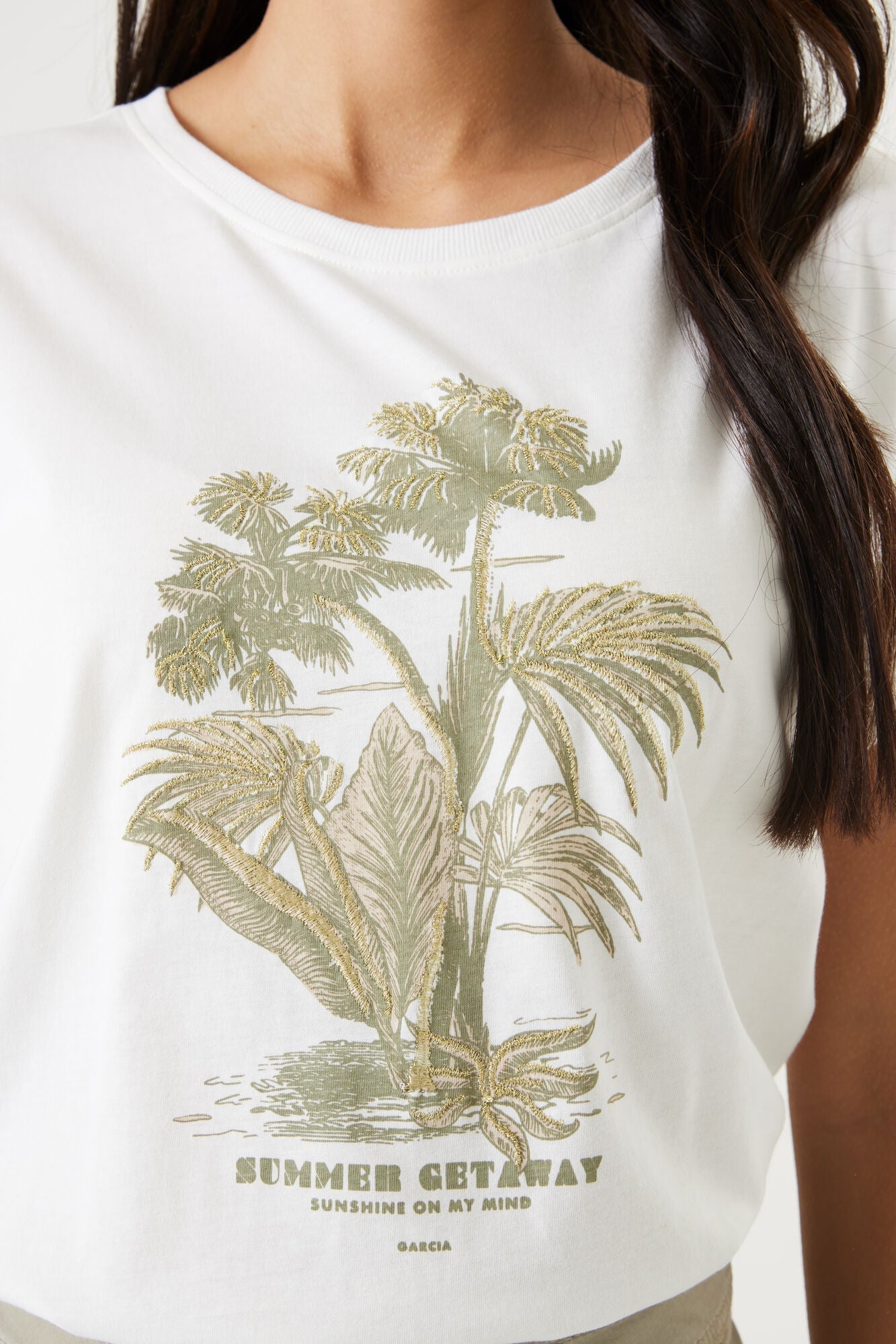 Close up of front graphic on Garcia (Q40015) Women's Short Sleeve Palm Tree Graphic Tee With Golden Embroidery Accents in White