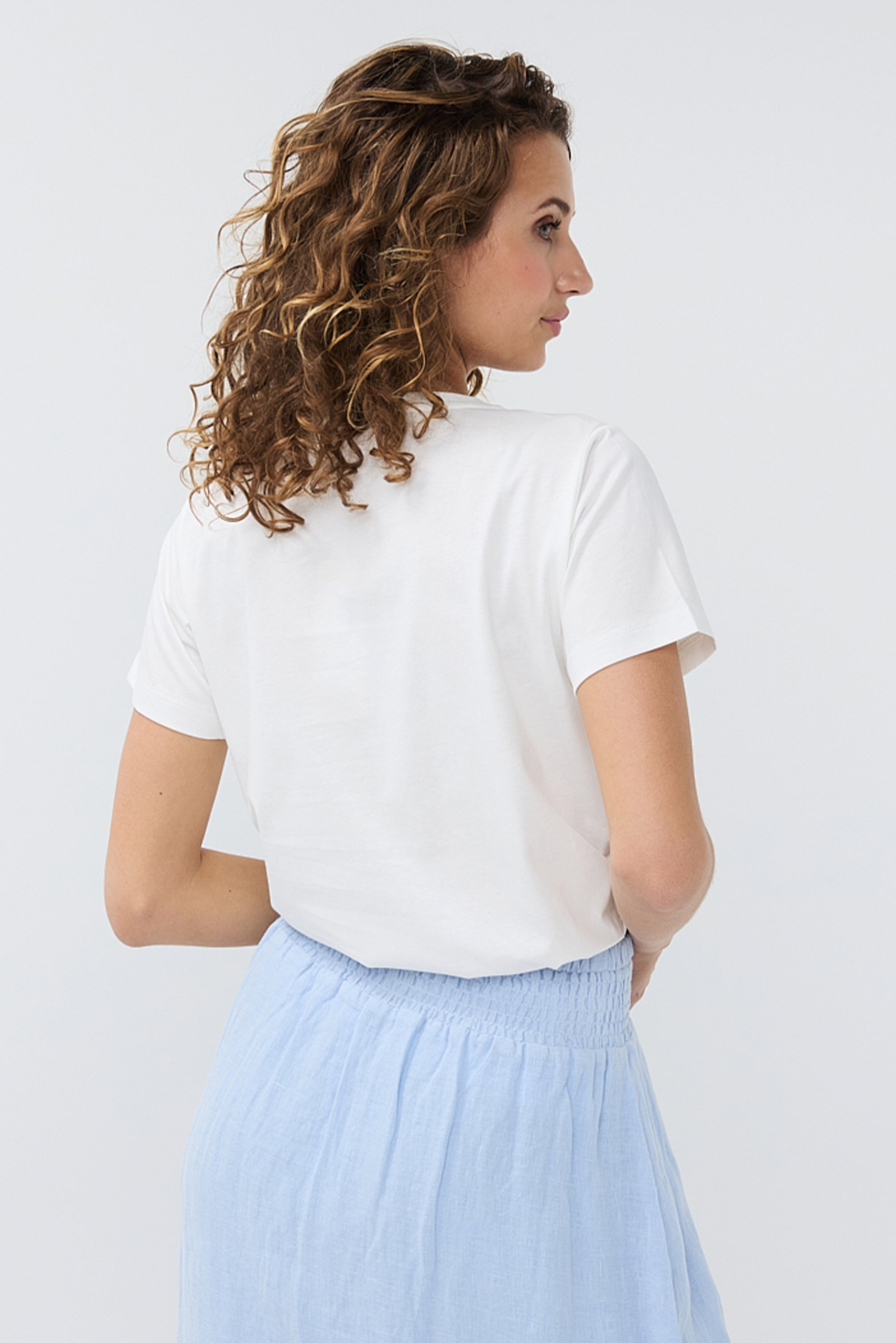 Back view of Women's Short Sleeve EsQualo Graphic T-Shirt (HS2405204) - Monochromatic beach scene with rhinestone cursive 