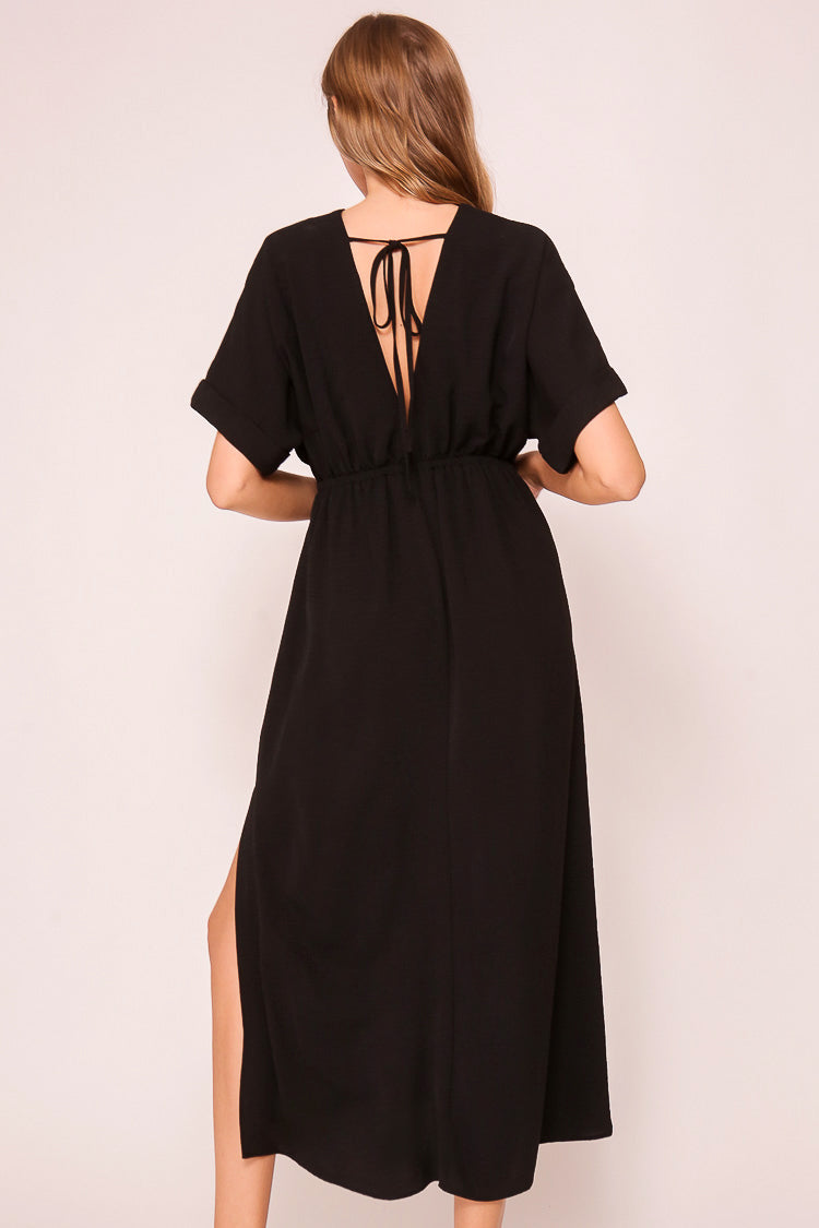 Back view of Timing (MD1924) Women's Short Sleeve Pleated Midi Dress with Plunging V-neck and back with Back Tie in Black