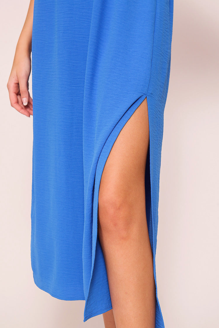 Close up of side split on Timing (MD1924) Women's Short Sleeve Pleated Midi Dress with Plunging V-neck and back with Back Tie in Blue