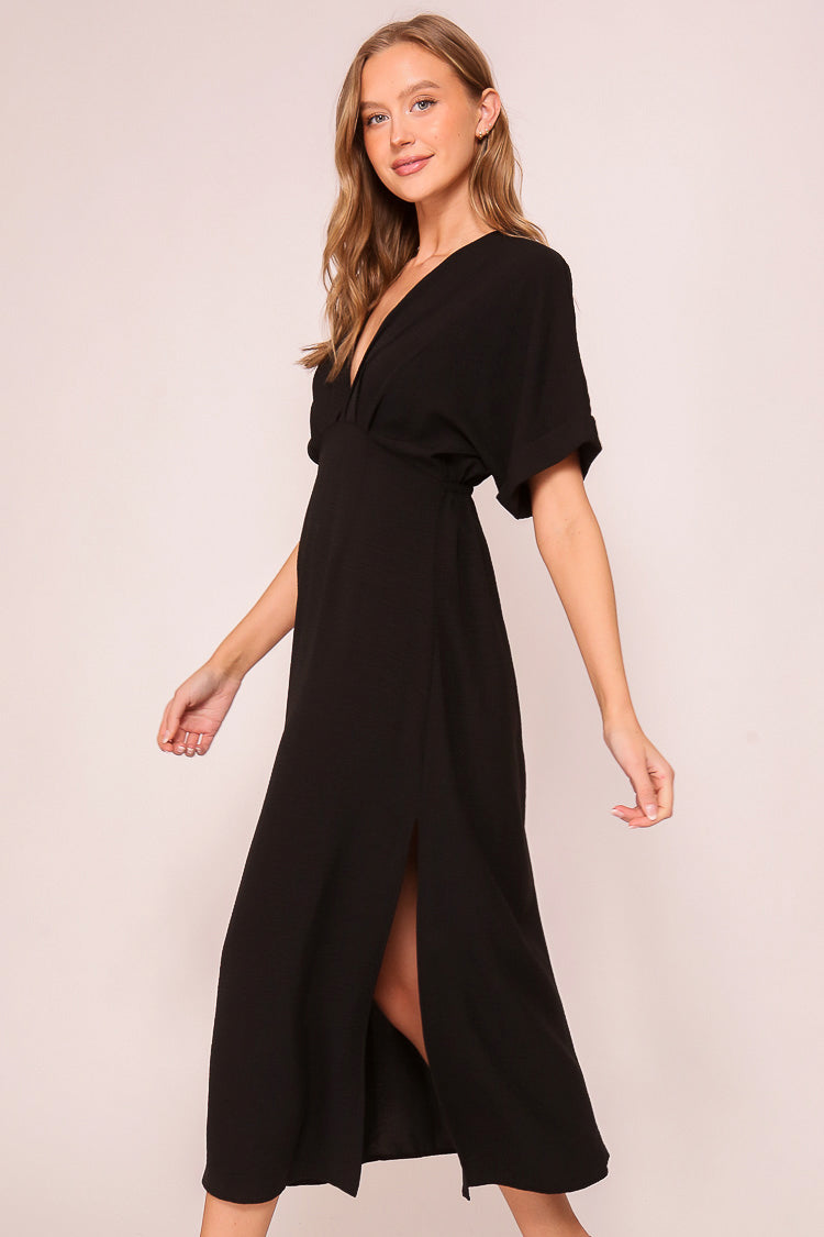 Side view of Timing (MD1924) Women's Short Sleeve Pleated Midi Dress with Plunging V-neck and back with Back Tie in Black