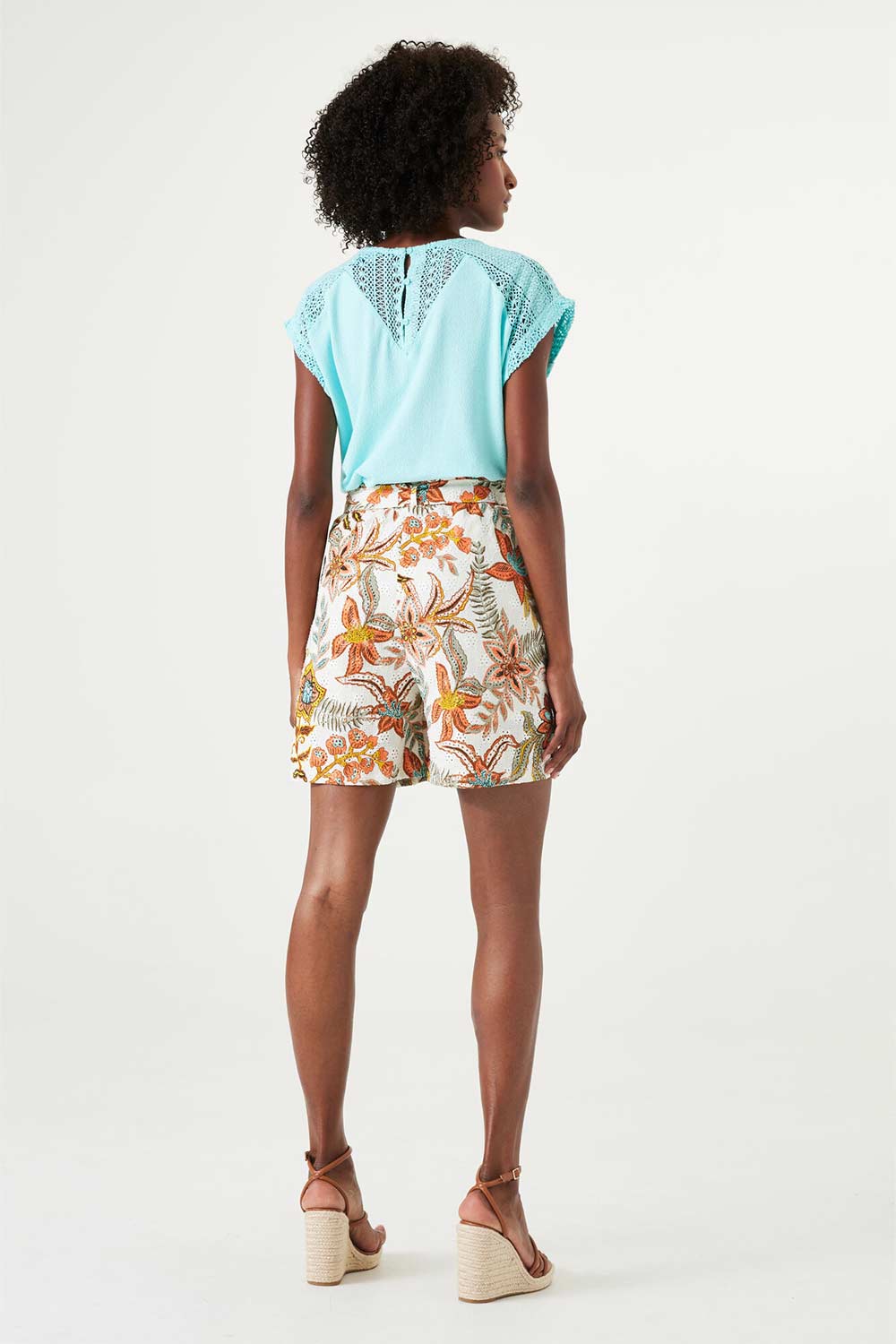 Back view of Garcia (Q40141) Women's High Rise Paper Bag Shorts with Tie Belt and Side Pockets in Retro Orange Floral Print