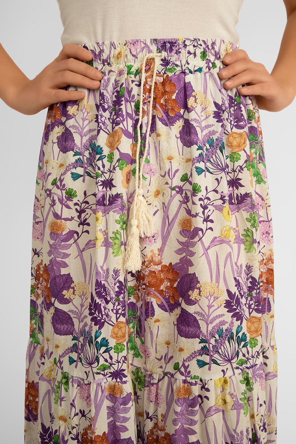 Close up of tassel drawstring waist on  Juilietta (H2142-M32_A3320-M2) Women's Maxi  Length Tiered Skirt in a Purple and multi-coloured floral print