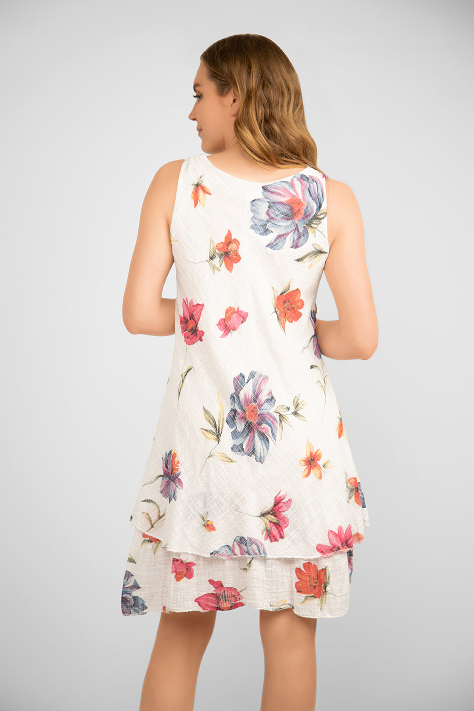 Back view of Me & Gee (S24-16-HL8903) Women's Sleeveless Floral Gauze Dress With Layered Knee Length Skirt in White with Floral Print