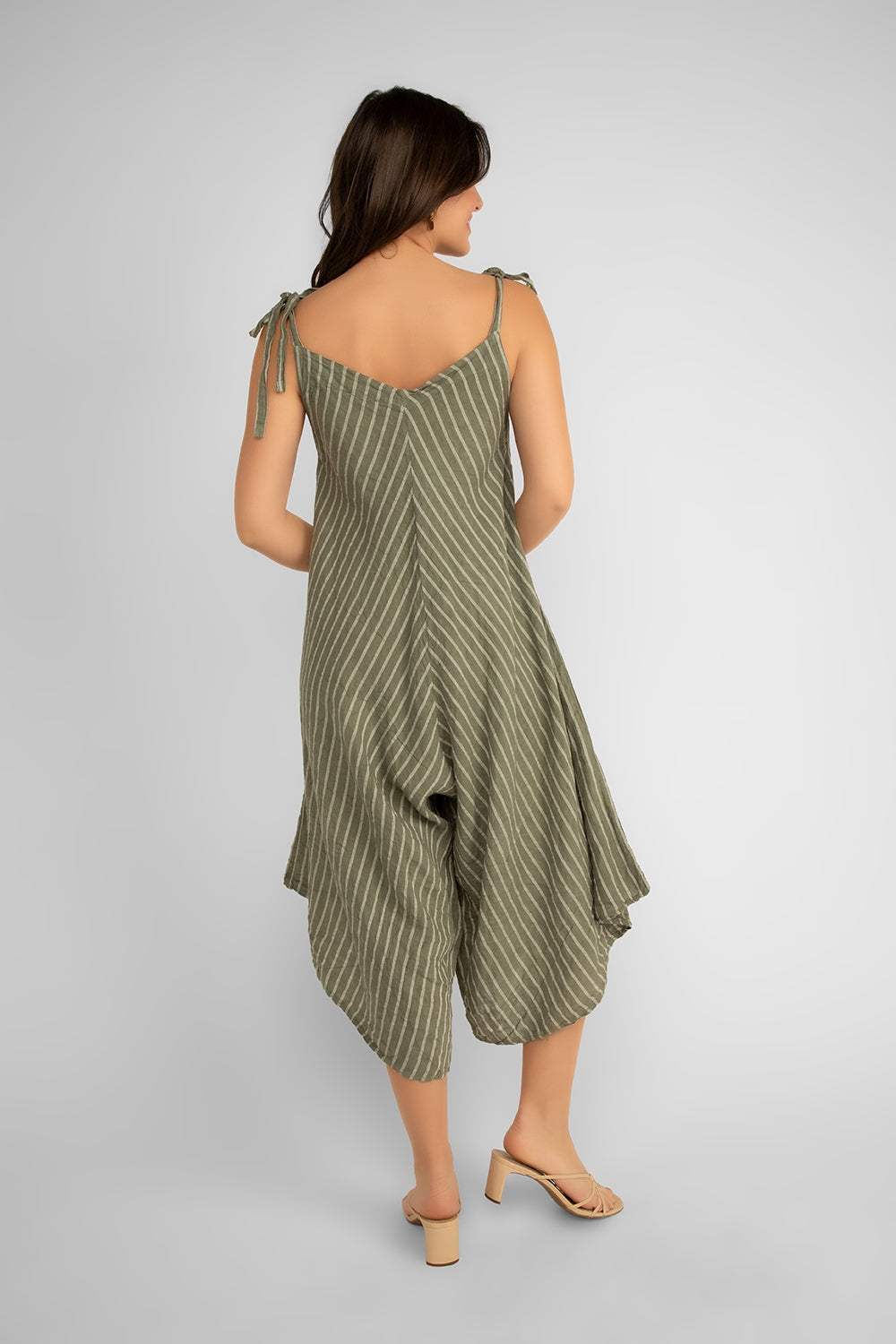 Back view of Women's (19-S59069) Women's Sleeveless Striped Linen Romper with adjustable tie straps, v-neck, and a cropped wide leg fit in Khaki & white stripes