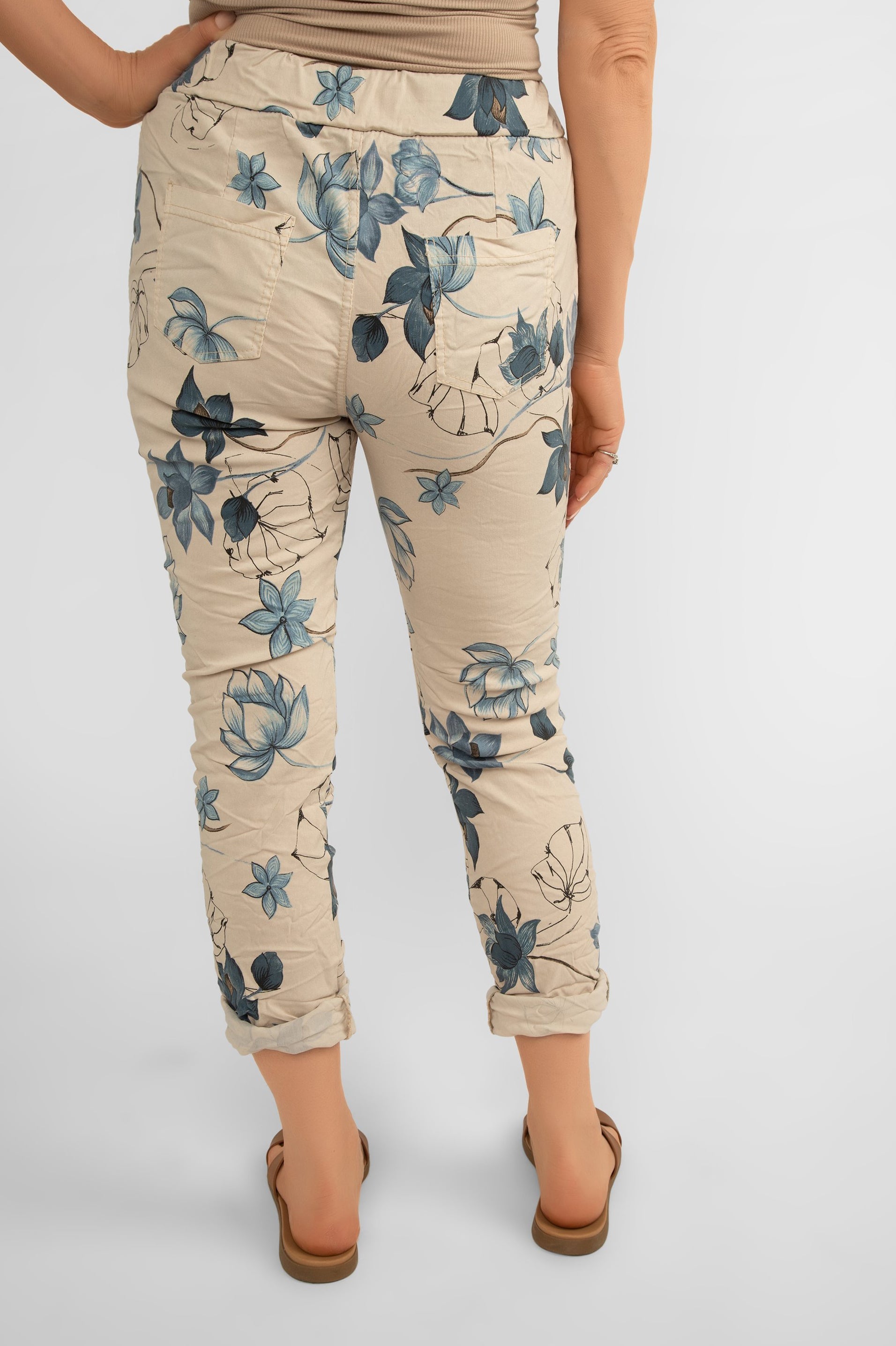 Back view of Bella Amore (21036) Women's Pull On Crinkle Pants with Side Pockets, Rolled Hem, and Blue Lotus Flower Print in Beige