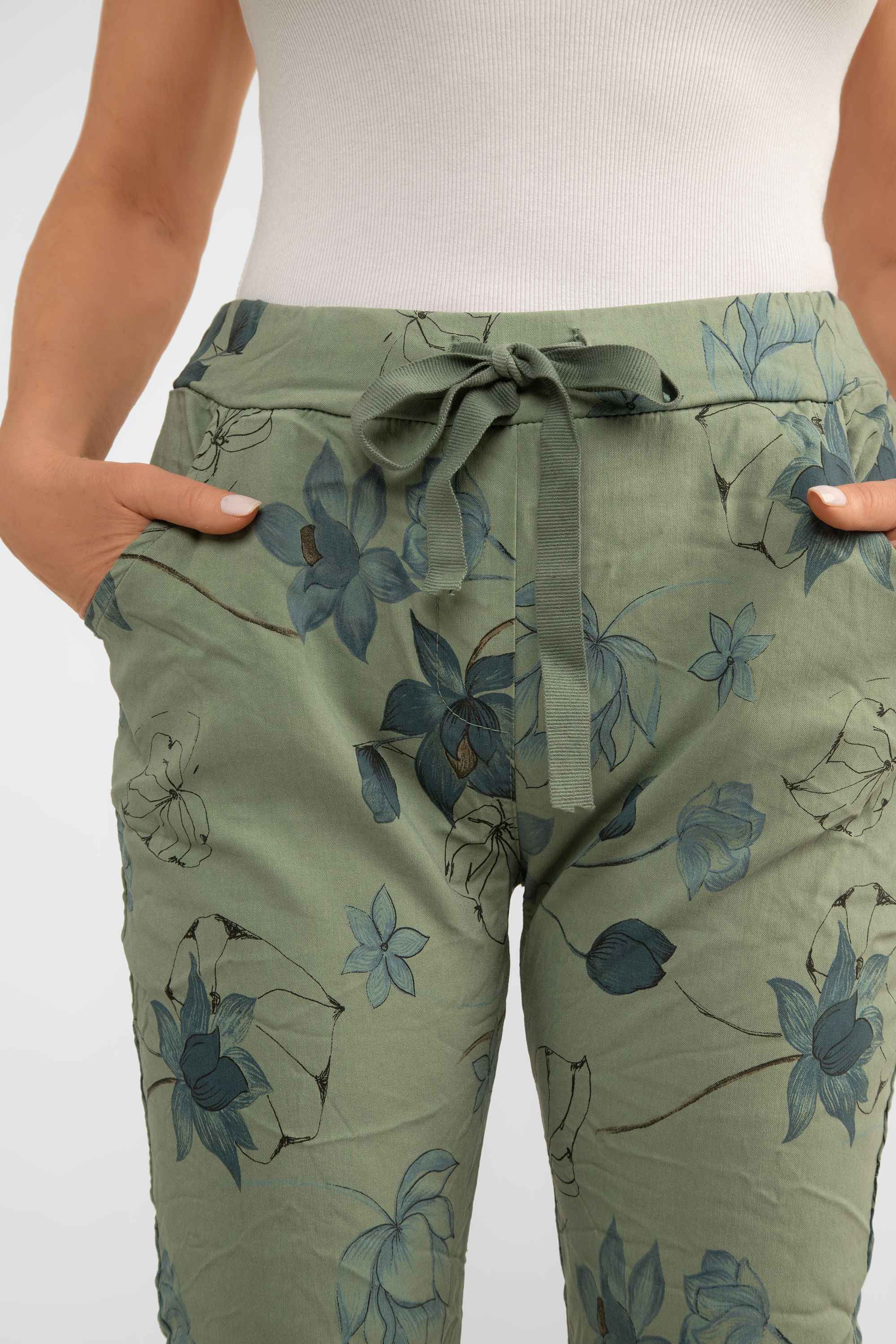 Close up front view of Bella Amore (21036) Women's Pull On Crinkle Pants with Side Pockets, Rolled Hem, and Blue Lotus Flower Print in Military Green