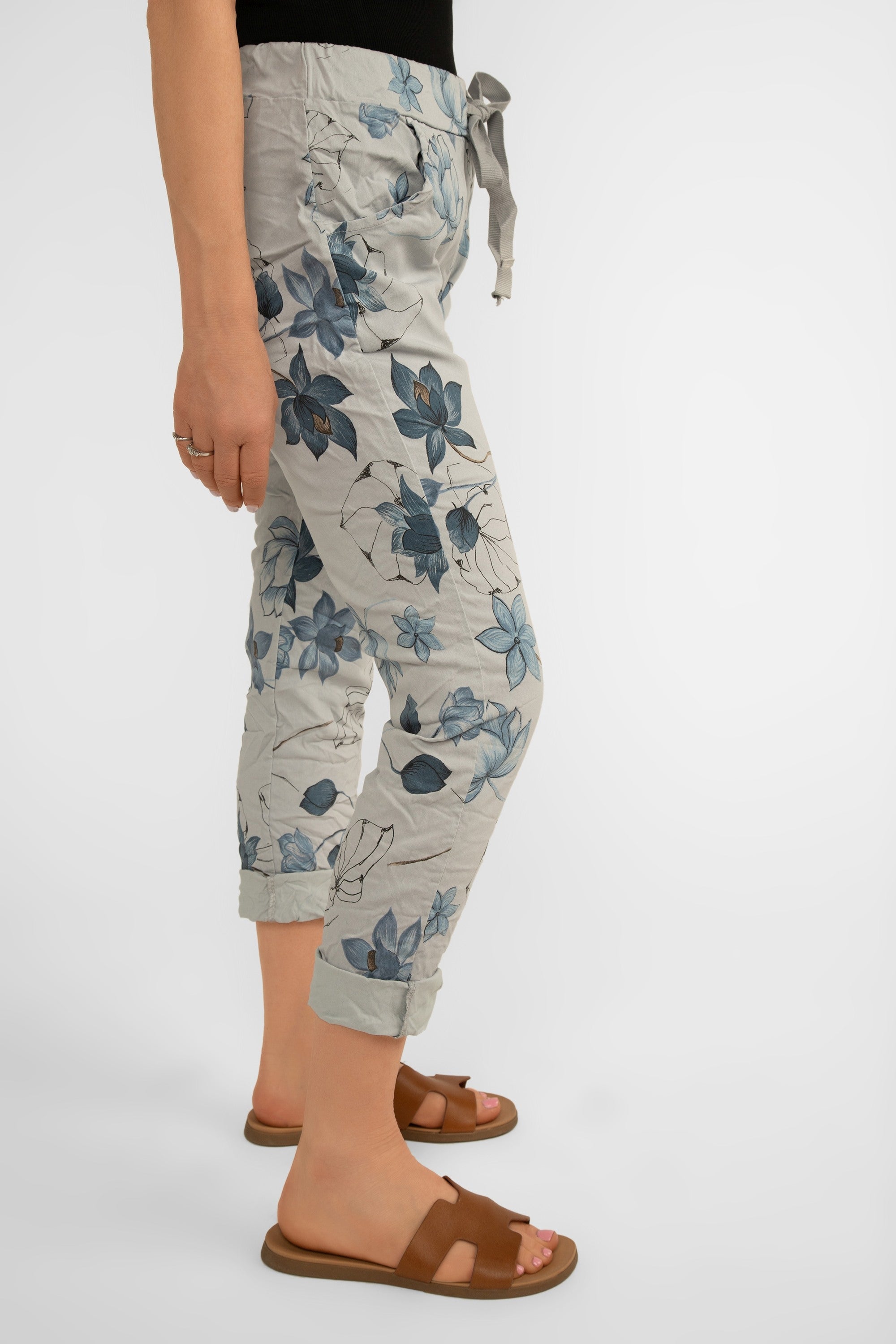 Side view of Bella Amore (21036) Women's Pull On Crinkle Pants with Side Pockets, Rolled Hem, and Blue Lotus Flower Print in Grey