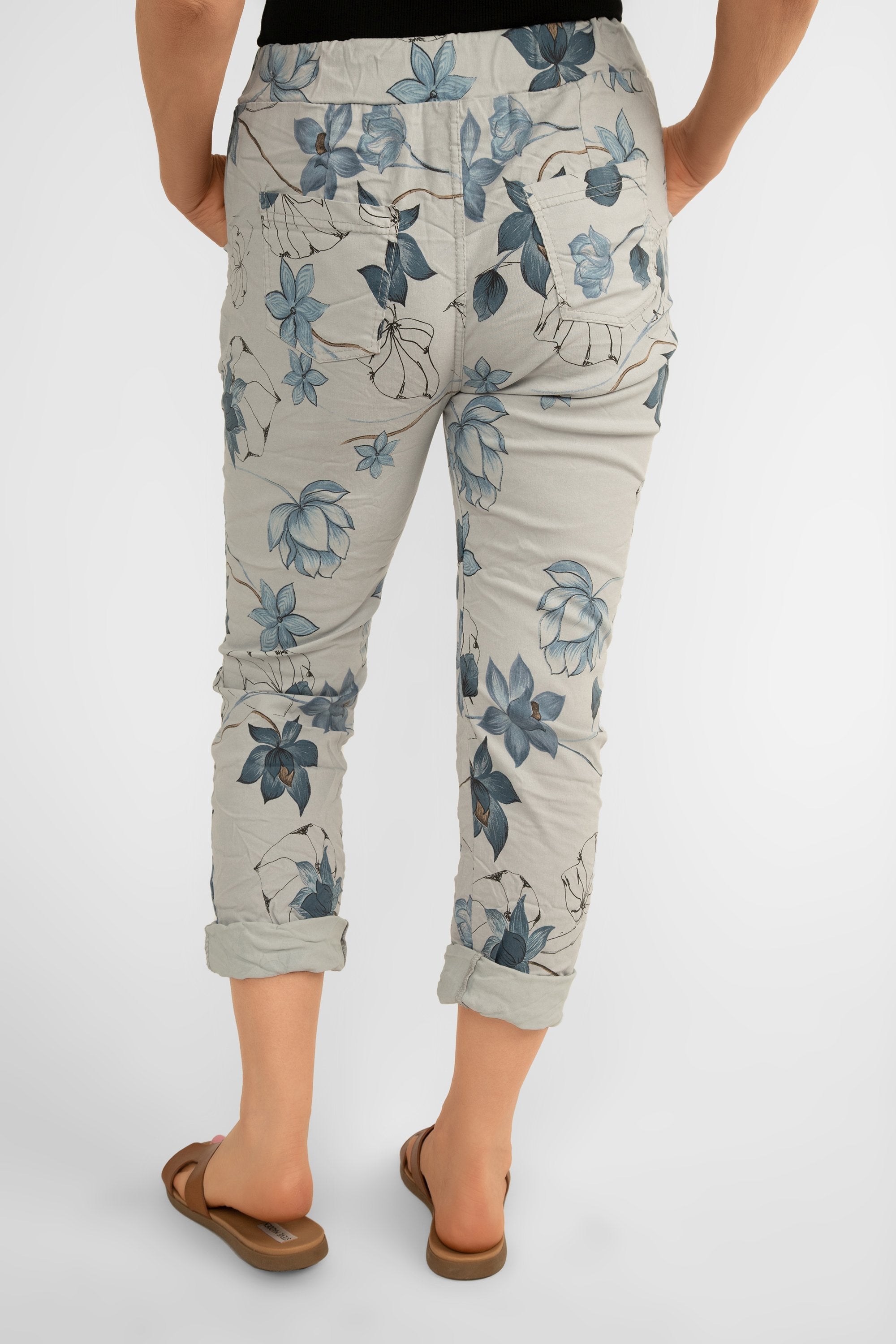 Back view of Bella Amore (21036) Women's Pull On Crinkle Pants with Side Pockets, Rolled Hem, and Blue Lotus Flower Print in Grey