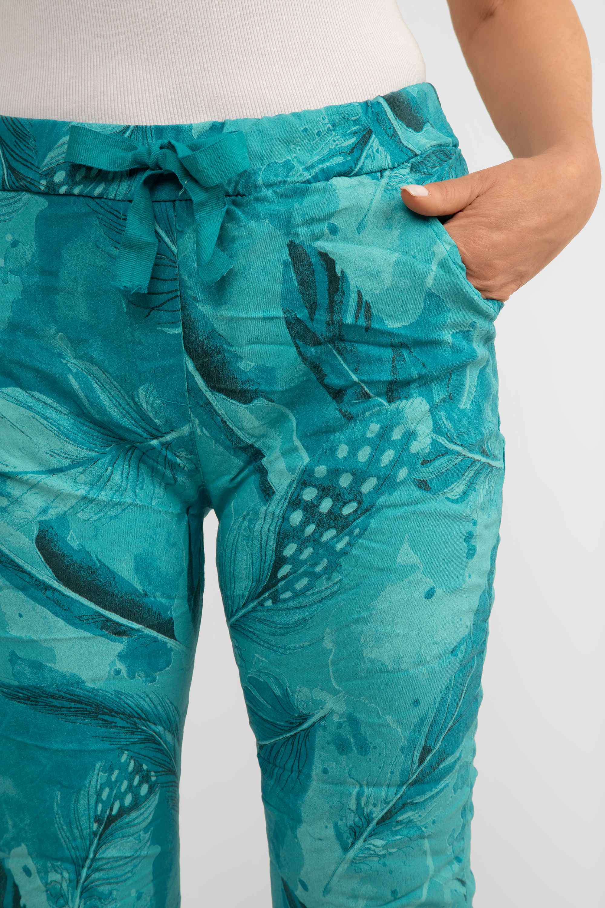 Front close up of Bella Amore (21144) Women's Slim Fit Cropped Crinkle Pants with Side Pockets, Pull-on waist in Teal Feather Print
