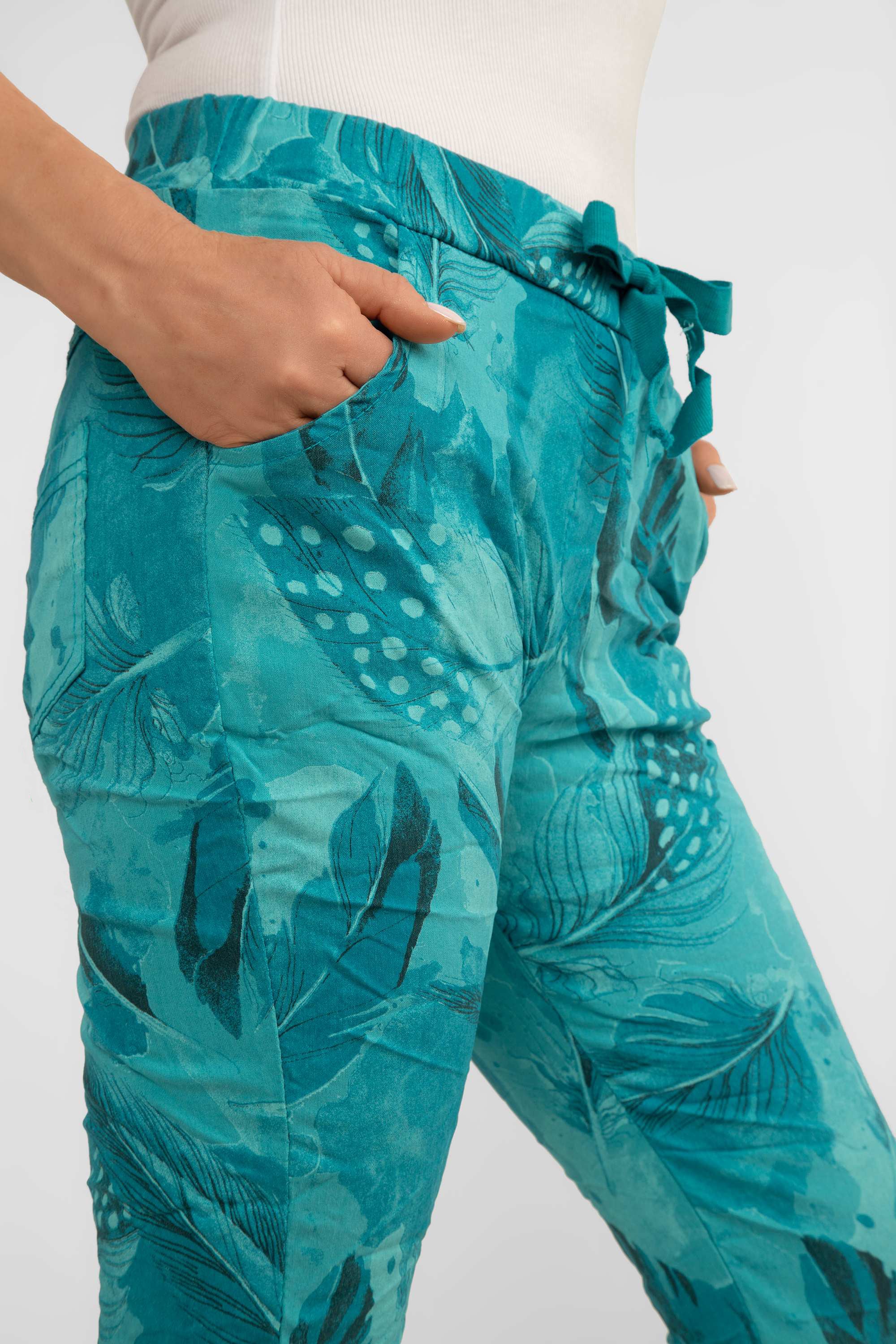 Side close up view of Bella Amore (21144) Women's Slim Fit Cropped Crinkle Pants with Side Pockets, Pull-on waist in Teal Feather Print