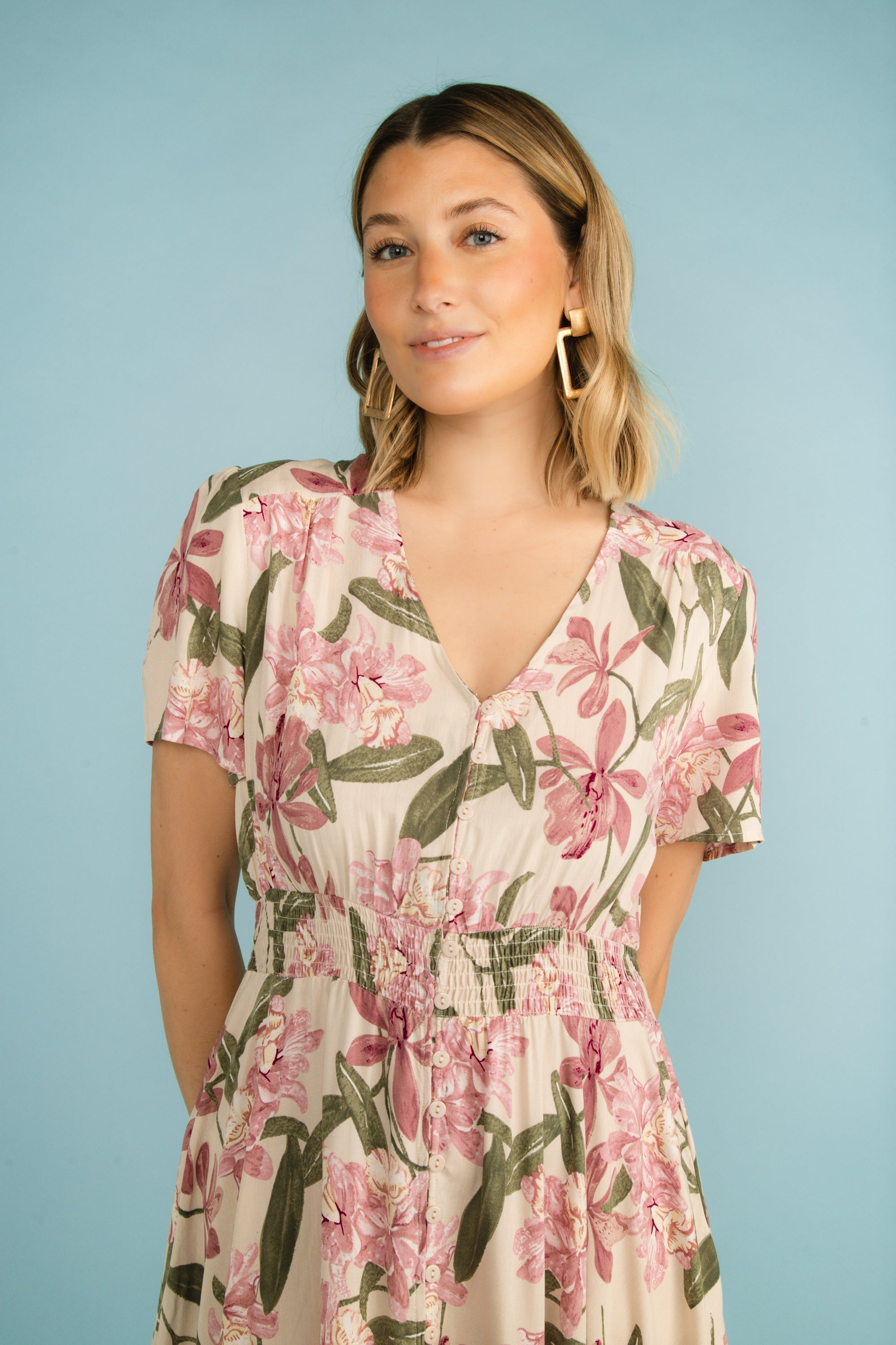 Front bodice of Funsport (241418) Women's Short Sleeve, V-neck Button Front Dress with a tiered maxi skirt in a pink floral print over a cream background