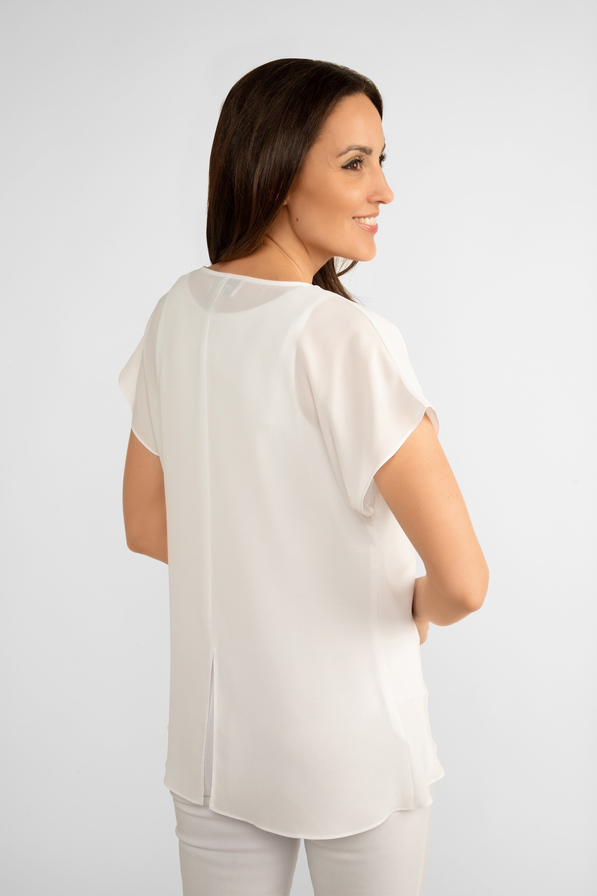 Back view of Joseph Ribkoff (242027) Women's Short Dolman Sleeve Georgette Fit and Flare Layered Top with Cowl Neck in Vanilla White