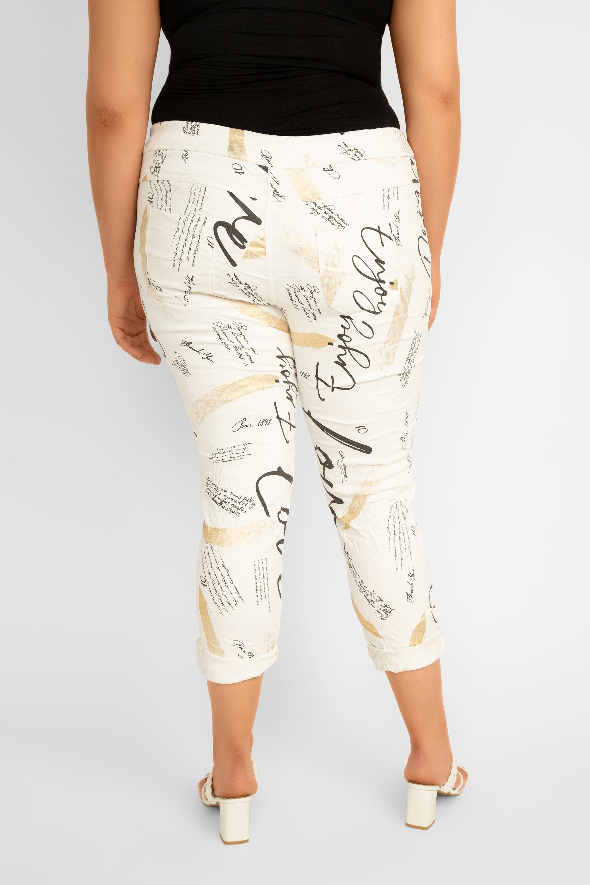 Bella Amore (68511) Women's Cropped Diagonal Zipper Pocket Pants in a Graphic print featuring black topography and gold foil streaks over a creamy white background