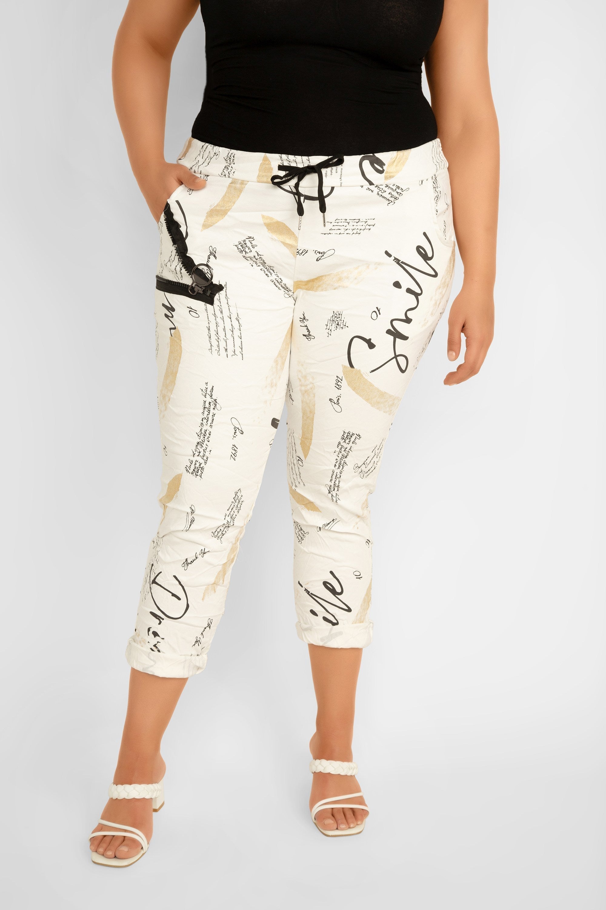 Bella Amore (68511) Women's Cropped Diagonal Zipper Pocket Pants in a Graphic print featuring black topography and gold foil streaks over a creamy white background