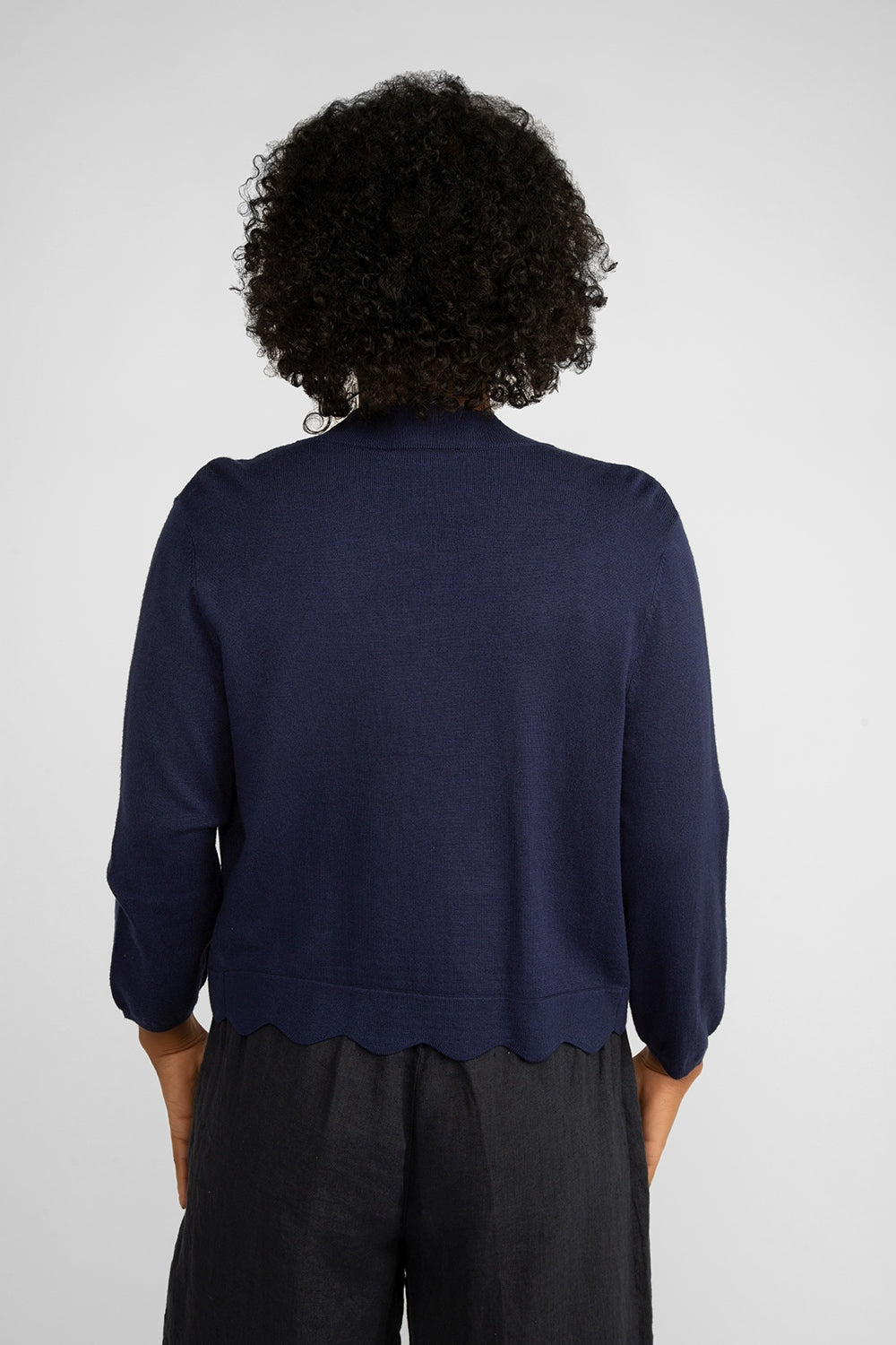 Back view of Carre Noir (6912) Women's Long Sleeve Lightweight Knit Open Front Cardigan with Scalloped Edges in Navy