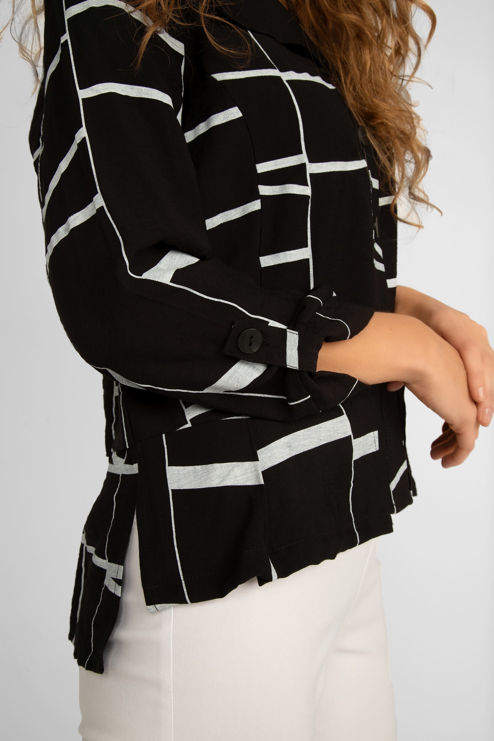 Side view of high low, pleated hem on Picadilly (JM565QO) Women's Long Sleeve Black & White Button Up Rayon Jacket
