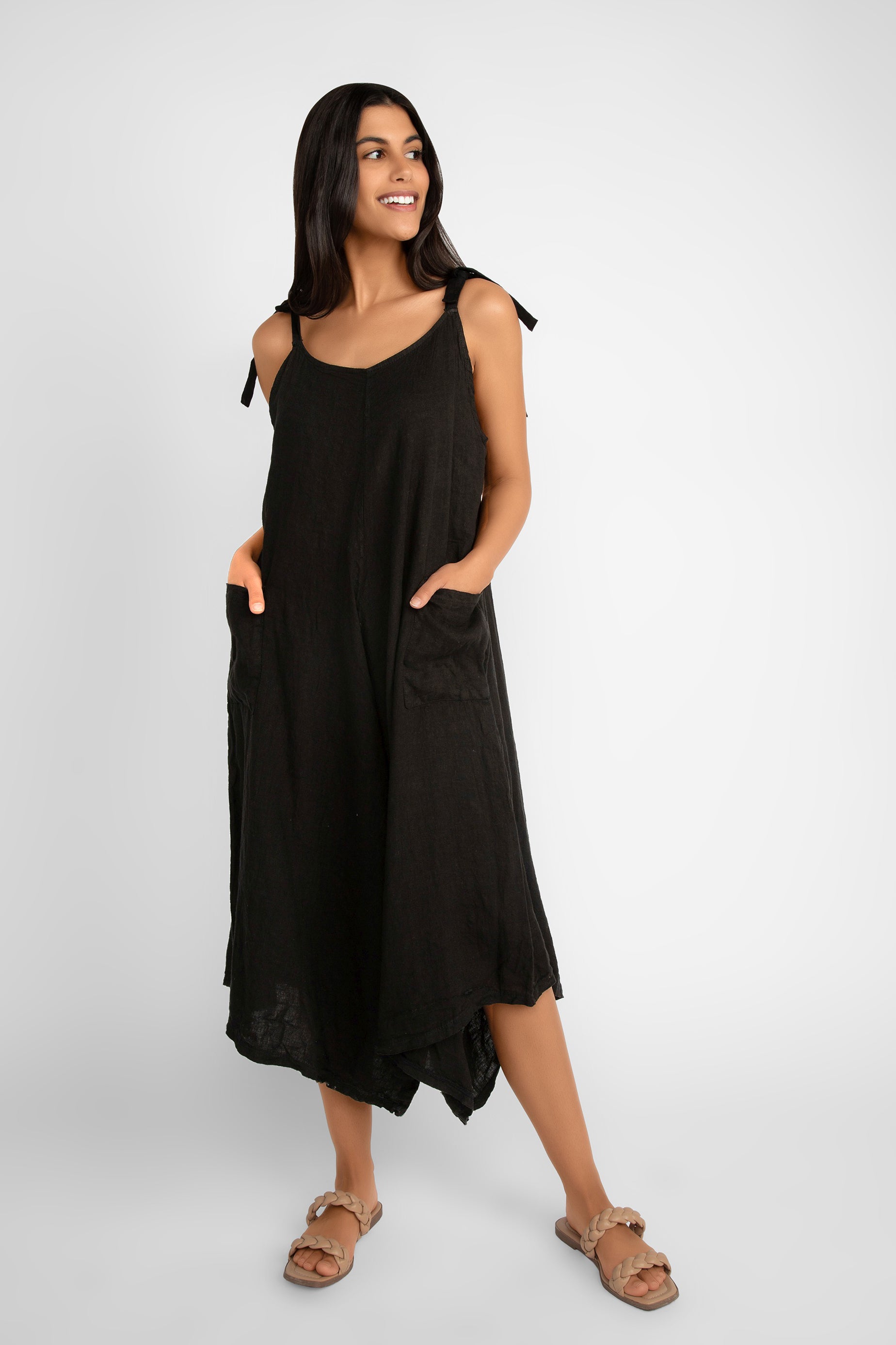 Front view of Me & Gee (L-6889) Women's Sleeveless Wide Leg Cropped Romper with Angled Hem and Front Pockets in Black 
