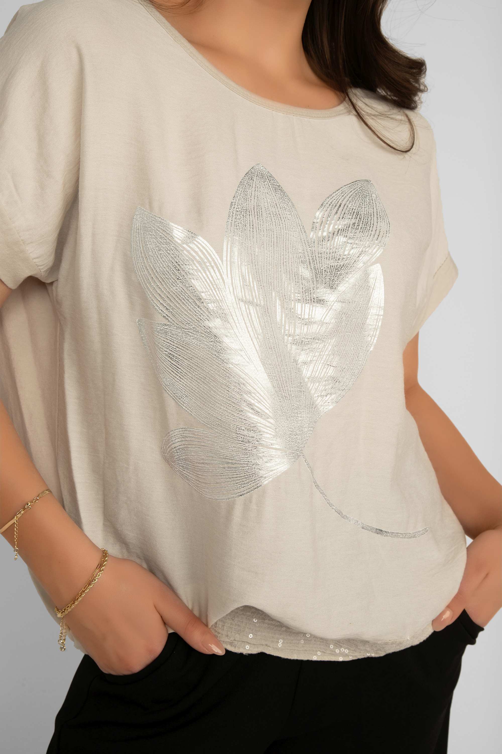 Close up front view of Elissia (LX35816) Women's Short Sleeve Cotton Blend Top with Foil Flower and Sequin Trim in Beige