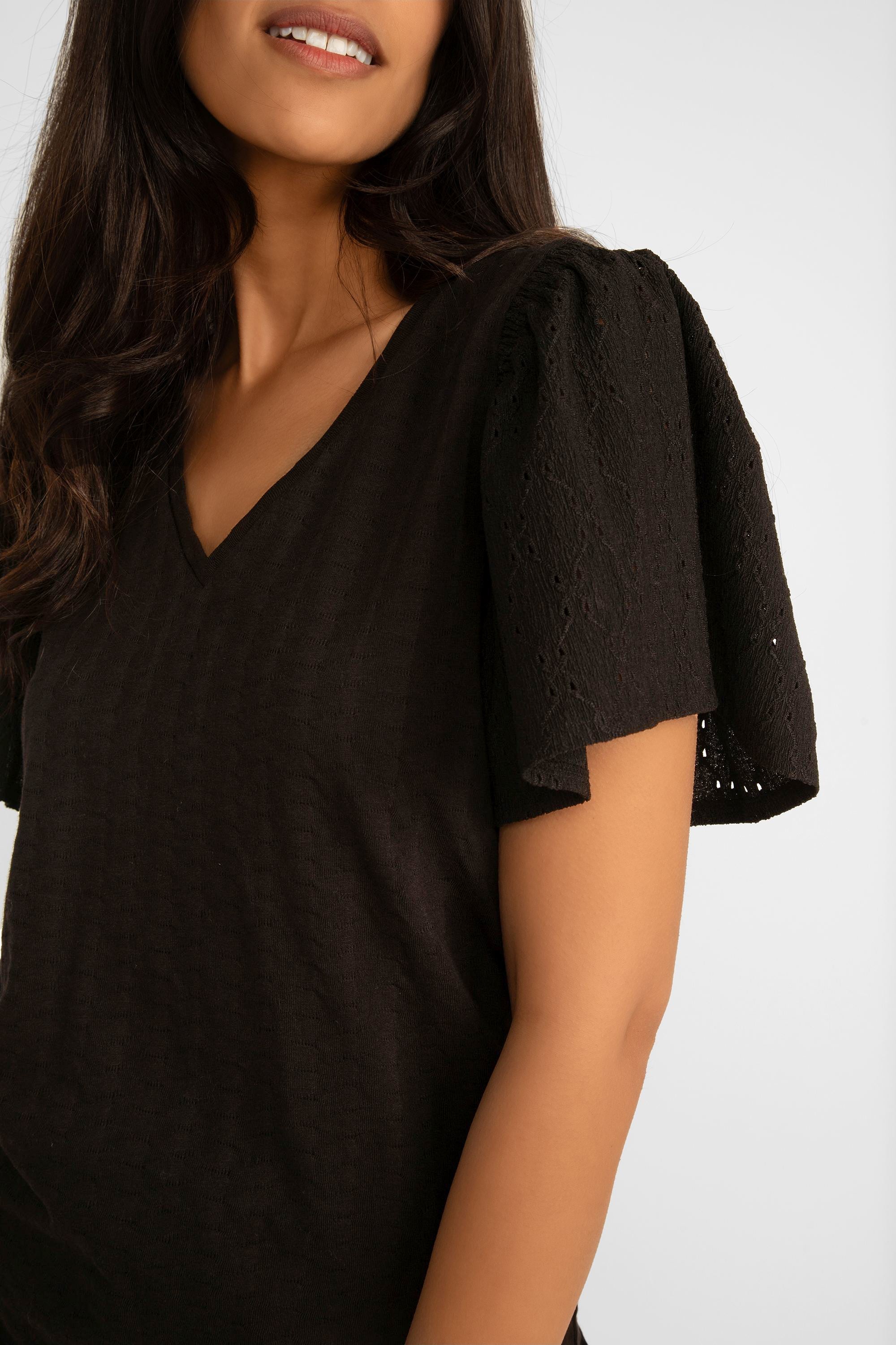 Close up of flounces sleeves on Garcia (P40209) Women's Textured Short Flounce Sleeve Top with V-neck in Black